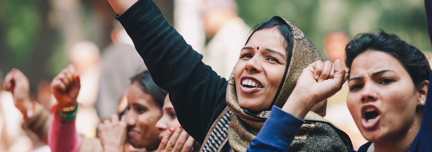 women raise arms in protest